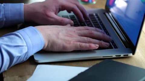 Man working on a macbook in cafe Stock Footage 71381037