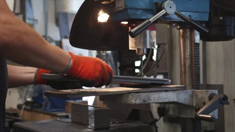 A man is working on a machine with a blue object on it Stock Footage 302458116