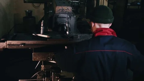 Man is working at a machine at a factory Stock Footage 76491915