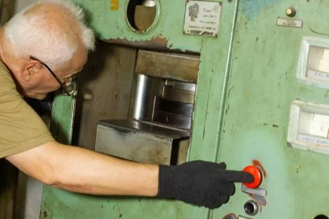 Man working on machine in a factory Stock Photos