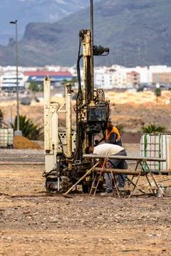 A man is working on a machine in a field Stock Photos