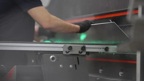 A man is working on a machine with a green light Stock Footage 302456917