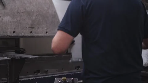 A man is working on a machine that has the number 50 on it Stock Footage 302458192