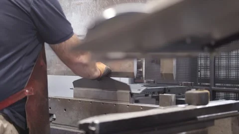 A man is working on a machine with a lot of metal parts Stock Footage 302457743