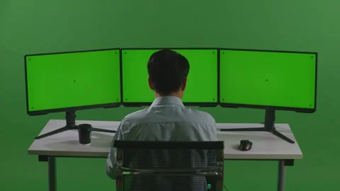 Man Working With Mock Up Multiple Computer Monitor In Green Screen Studio Stock Footage 249624865