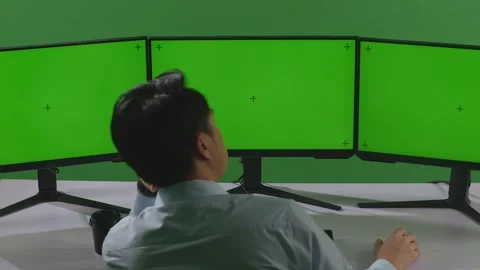 Man Working With Mock Up Multiple Computer Monitor In Green Screen Studio Stock Footage 249634085