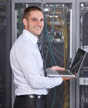 Man working in a modern datacenter server room Stock Photos