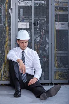 Man working in a modern datacenter server room Stock Photos