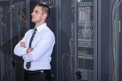 Man working in a modern datacenter server room Stock Photos