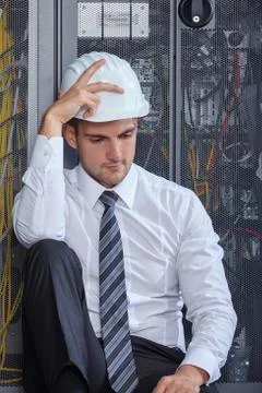 Man working in a modern datacenter server room Stock Photos