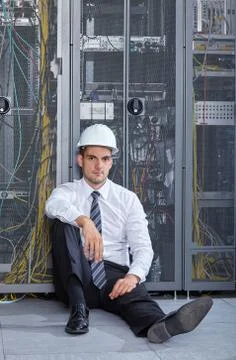 Man working in a modern datacenter server room Stock Photos