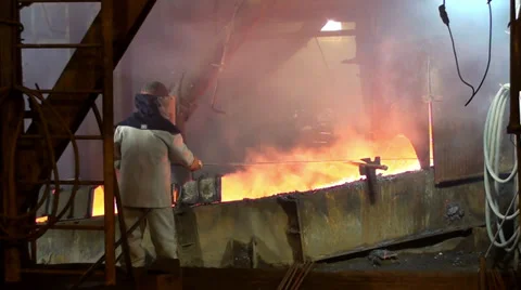 Man working with molten metal Stock Footage 34368390