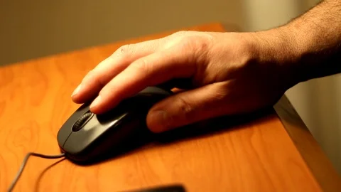 Man working a mouse on a desk top Stock Footage 91176759