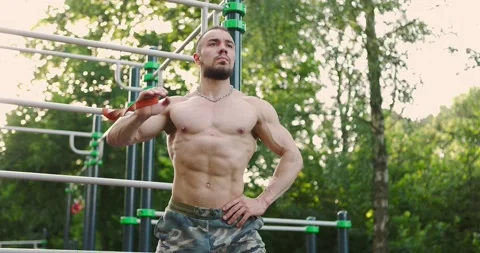 Man working muscles practicing with resistance band.Athlete doing triceps Stock Footage 157452757