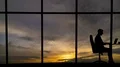 The man working near the window with a cloud stream view 4k or 4k+ Resolution