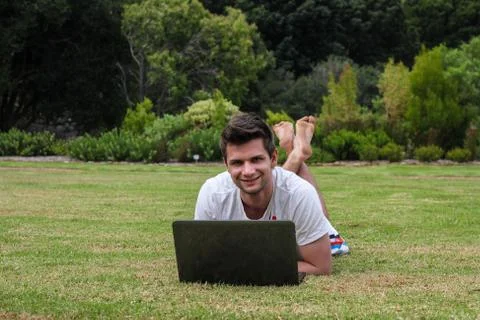 Man working on notebook outdoors Stock Photos