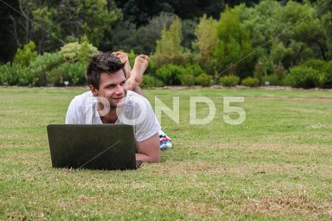 Man working on notebook outdoors Stock Photos