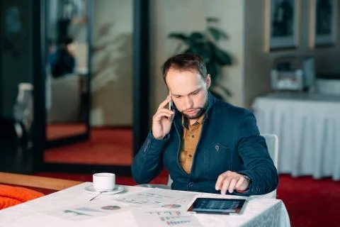 Man Working in Office and Analyzing Some Statistical Calculation Reports. 스톡 사진