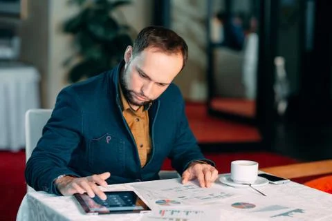 Man Working in Office and Analyzing Some Statistical Calculation Reports. Stock Photos