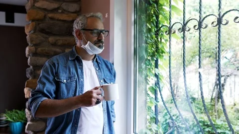 Man working in the office and looking out the window with coffee. Stock Footage 135796834