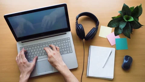 Man working at office desk with his laptop, hands top view, timelapse shot Stock Footage 87379088