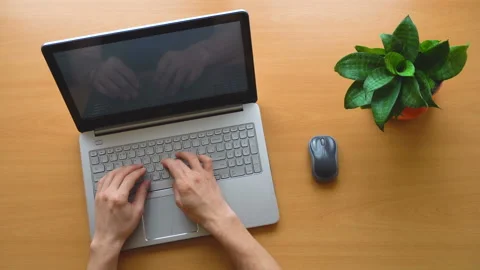 Man working at office desk with his laptop, hands top view, timelapse shot Stock Footage 87381561