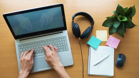 Man working at office desk with his laptop, hands top view, timelapse shot Stock Footage 87777016