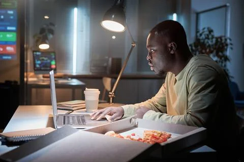 Man working at office during deadline Stock Photos