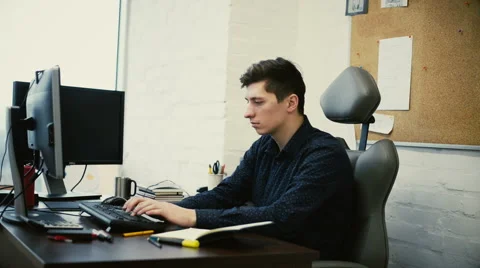 Man working in office in front of desktop computer Stock Footage 59986042