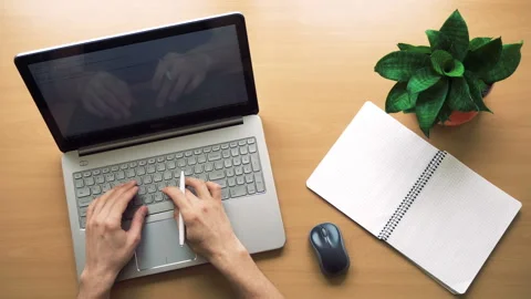 Man working at office with laptop and notepad, hands top view Stock Footage 87380366