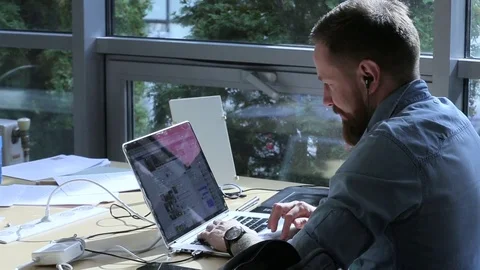 A man working in office at a laptop Stock Footage 70587277