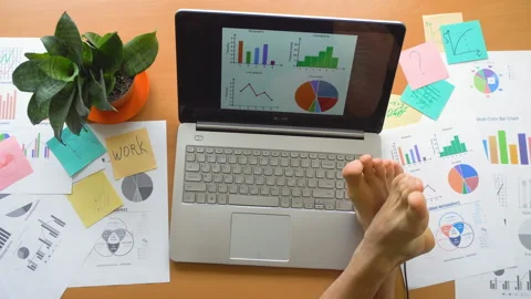 Man working at office with laptop surrounded by a lot of paperwork, top view Stock Footage 87382318