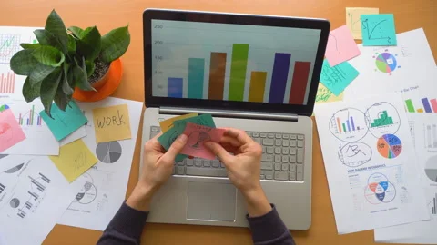 Man working at office with laptop surrounded by a lot of paperwork, top view Stock Footage 87446500