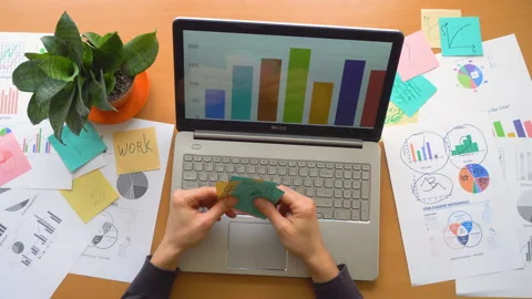 Man working at office with laptop surrounded by a lot of paperwork, top view Stock Footage 87781440