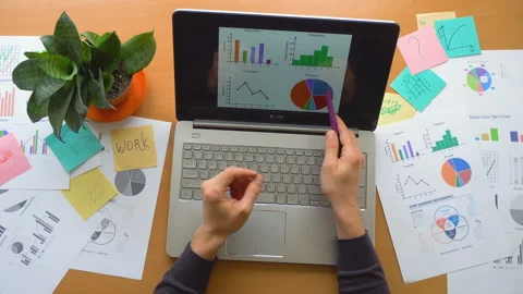 Man working at office with laptop surrounded by a lot of paperwork, top view Stock Footage 87977893