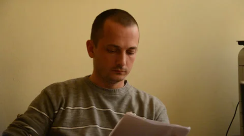 Man working in the office, reading papers Stock Footage 39764323