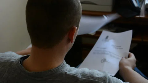Man working in the office, reading papers Stock Footage 39764431
