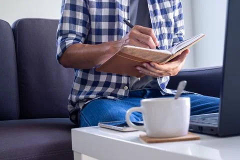 A man working or study online in the living room on the sofa. due to the spre Foto stock