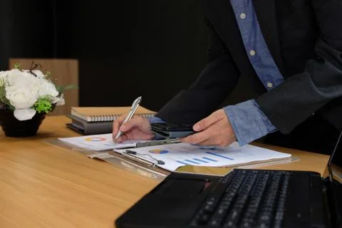 Man working organizing plan with smart phone. businessman analyzing document  Stock Photos