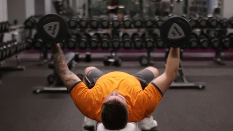 A man working out and training his arms and shoulders exercise with dumbbell Stock Footage 83129089