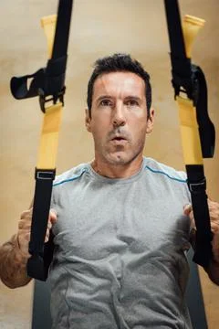 Man working out at a gym. Stock Photos