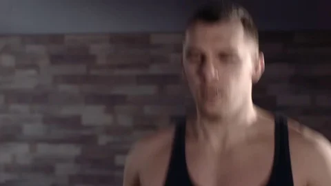 Man working out jumping rope in a gym Stockbeeldmateriaal 77325101