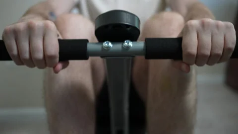 Man Working Out With Rowing Machine at Home Stock Footage 252597240