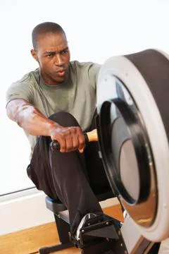 Man Working Out On Rowing Machine Stock Photos