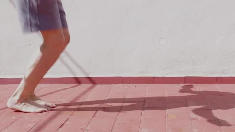 Man working out with a skipping rope on the terrace of his house Stock Footage 140809005
