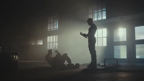 Man working out with trainer Stock Footage 236180797