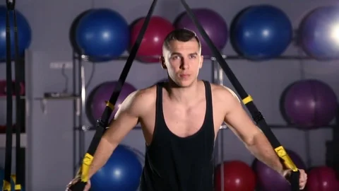 Man working out on trx in a gym Stockbeeldmateriaal 76471199