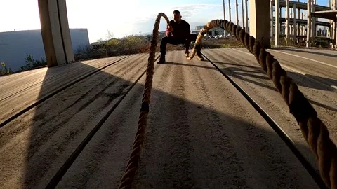 Man working out using battle ropes Stock Footage 135059347