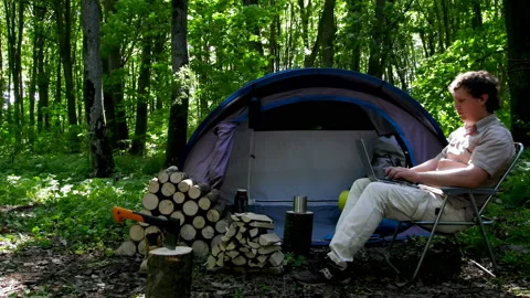 Man Working Outdoors In A Tent Camp. Stock Footage 93045473
