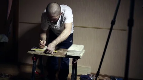 Man working outlines on the wall of the bar for the box Stock Footage 69932552